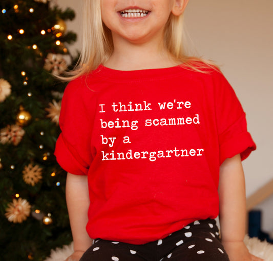 I Think We're Being Scammed By a Kindergartner - Short Sleeve Kids Shirt