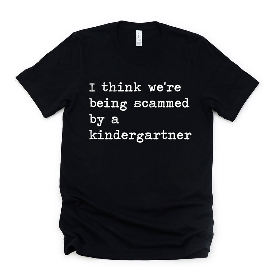 I Think We're Being Scammed By A Kindergartner Unisex Tee