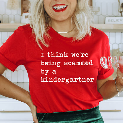 I Think We're Being Scammed By A Kindergartner Unisex Tee